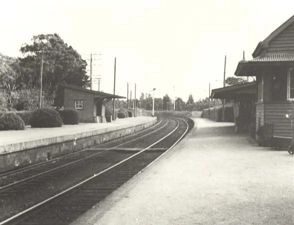 Exeter railway station platforms and curved tracks in a historic photograph.