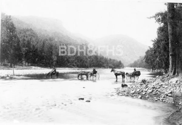 Official party crossing the Wollondilly River on the new road to Wombeyan Caves in 1899.