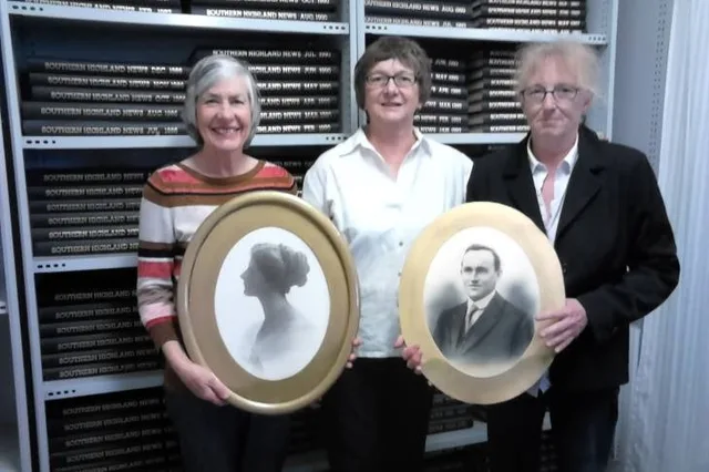 Denise Mackey at left, Linda Emery in the centre and Roberta Stove at right, holding restored photographs in 2016.