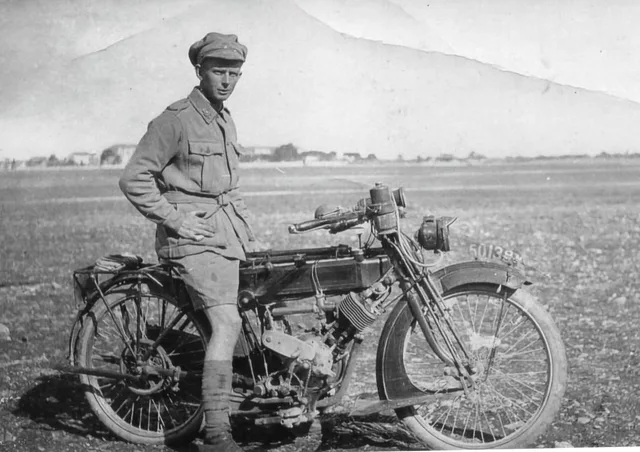 Albert Reynolds standing beside a motorcycle, dated 1917-1919 in the Society caption.