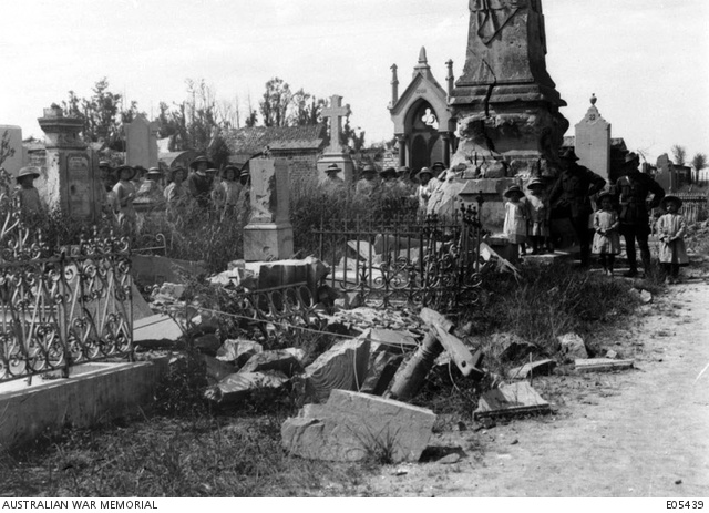 French children and Australian soldiers at the damaged cemetery in Villers-Bretonneux