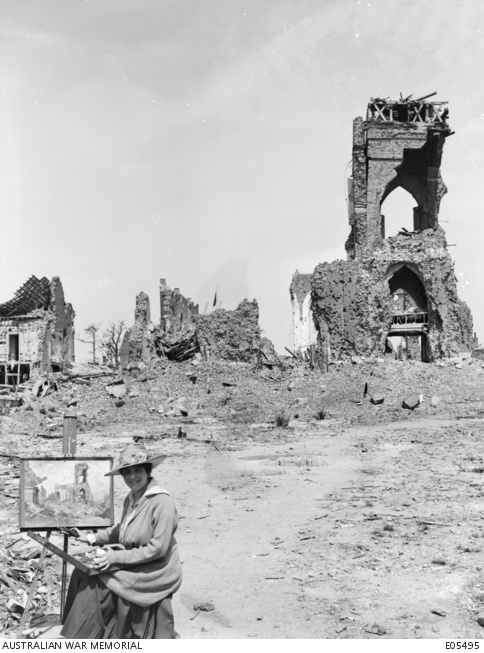 Artist Evelyn Chapman at work among the ruins of the church at Villers-Bretonneux