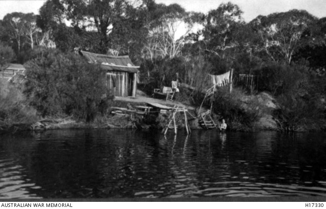 An internee swimming beside a hut on the Wingecarribee River at Berrima, circa 1918.