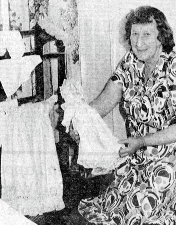 Society museum committee member Clarice Boyd holding a doll at the museum