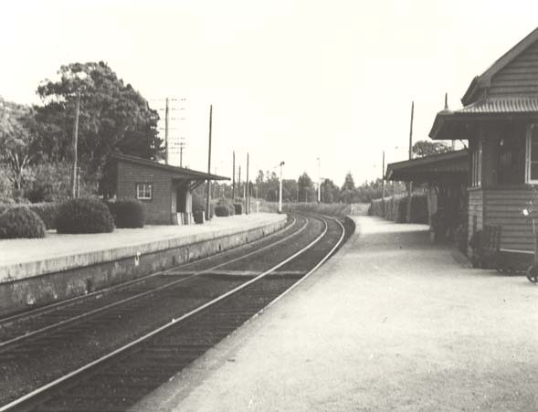 Exeter railway station platforms and curved tracks in a historic photograph.