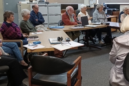 People seated together at a family history group meeting
