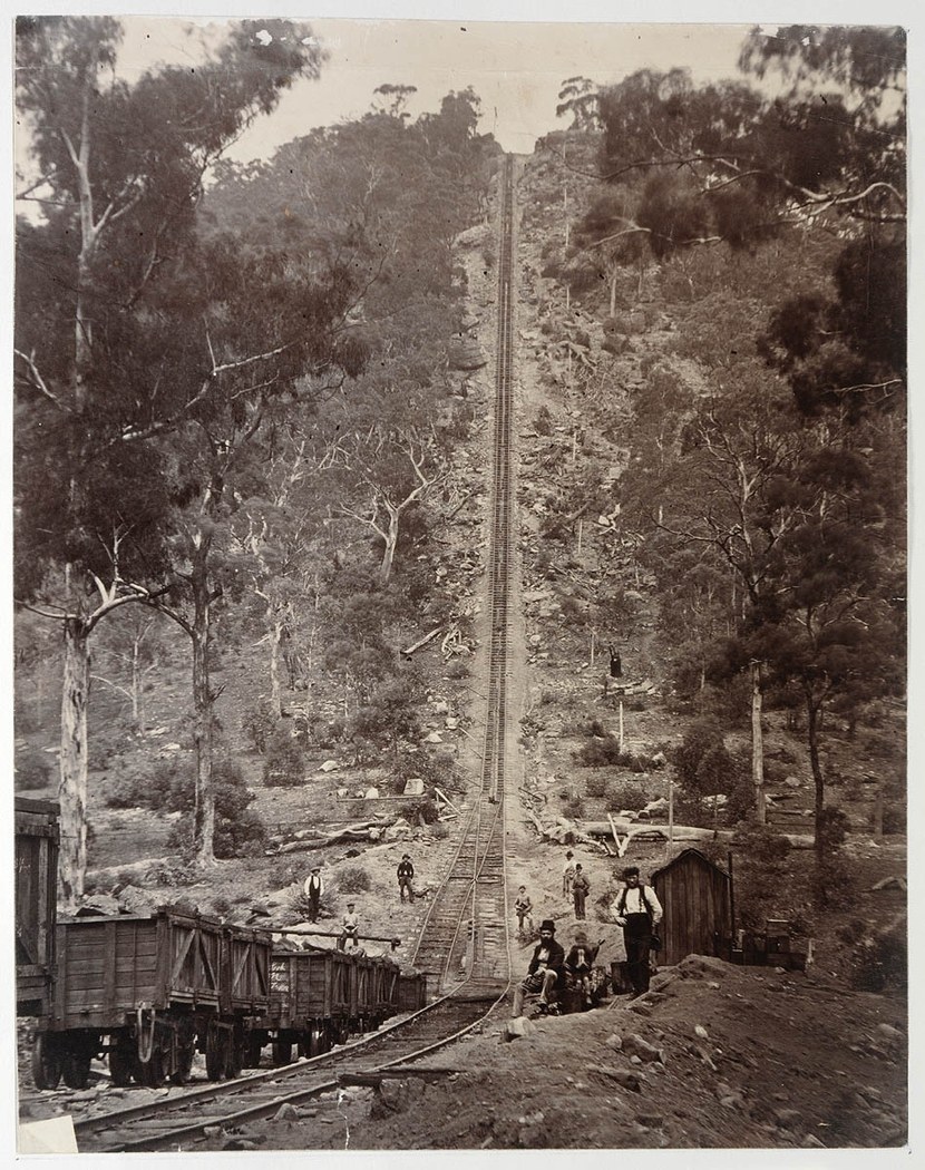 A steep rail incline, wagons and people at Joadja, photographed around 1885.