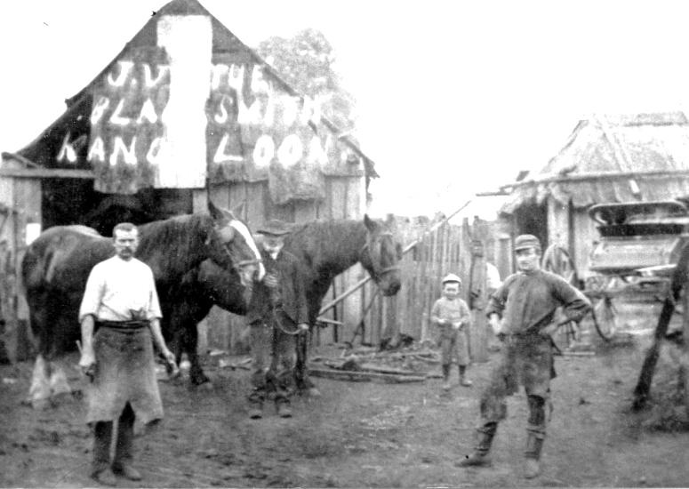 People and horses outside Mr Virtue’s blacksmith shop at Kangaloon
