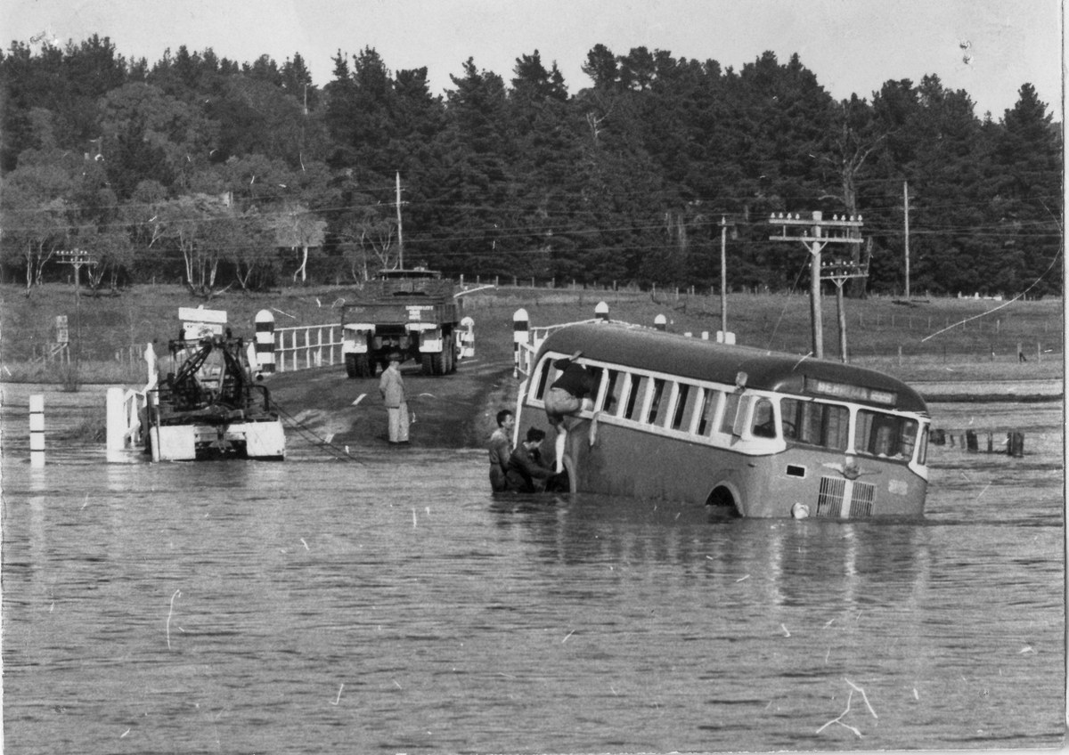 Bus partly submerged in floodwater at Moss Vale in the 1950s.