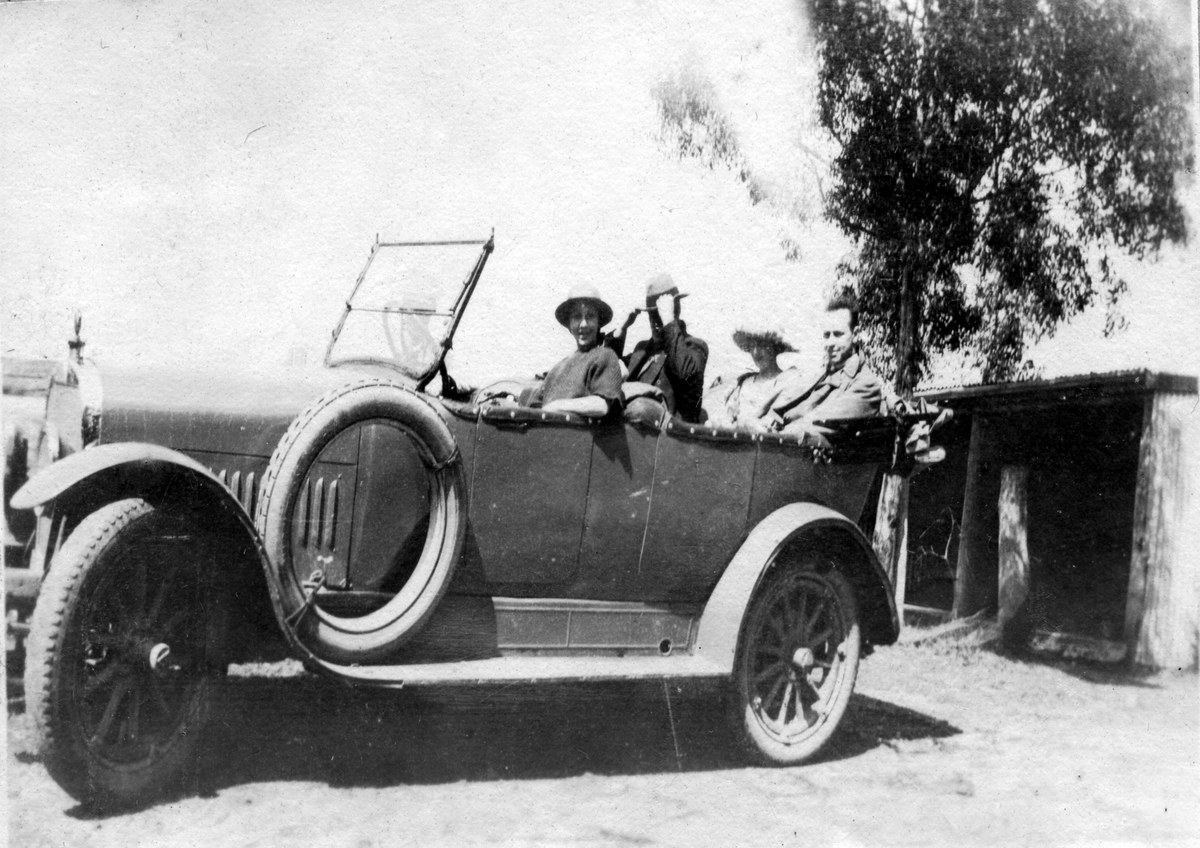 Four adults seated in an open-roofed touring car, Moss Vale, 1921-1926.
