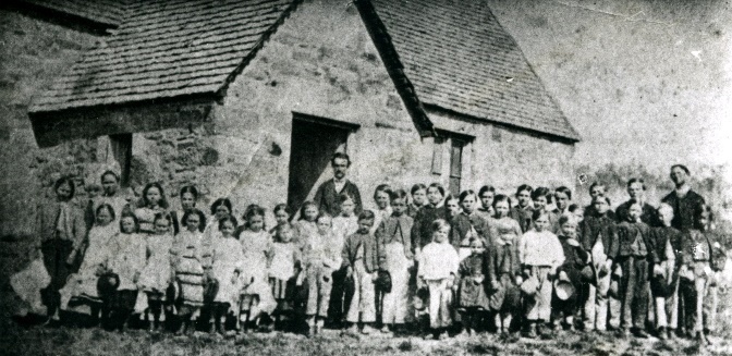People outside the stone church and school associated with Rowes Hill