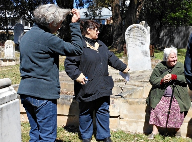 Carol Nolan, seated, with Carolyn Dougherty and Ros Dale at Rowes Hill cemetery