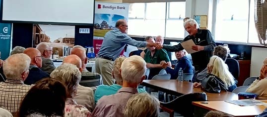 A former cement works apprentice receives his award at the Society’s newsletter launch