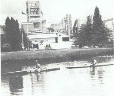 Peter Cook and Stephen Barratt practising in concrete canoes with Berrima Works behind them