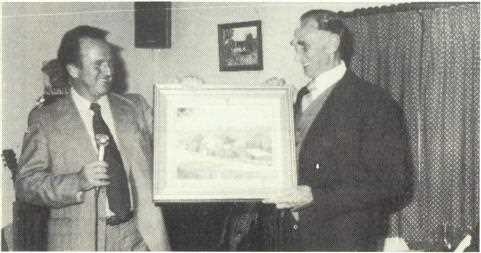 Ian Hewitt presents a gift to Col Pickering at his farewell